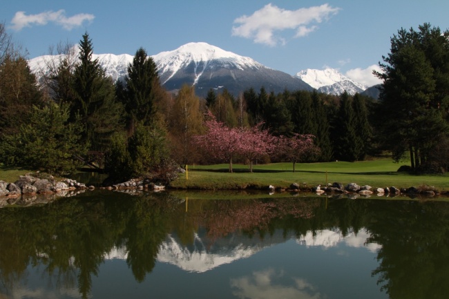 Slovenia and the greenest golf in Europe Golf swings with a mountain, lake and forest view